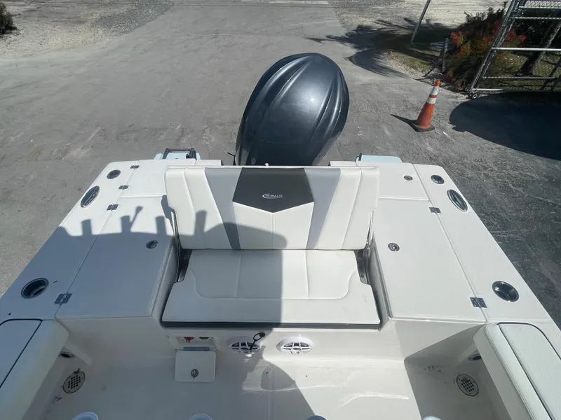 Slide: The Image of 2023 Robalo 246 Cayman boat interior with seating and engine view. - 16