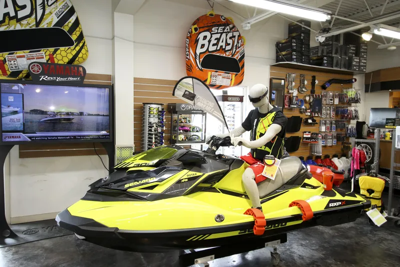 Slide: The Image of Mannequin on a yellow jet ski in a marine equipment store display. - 24