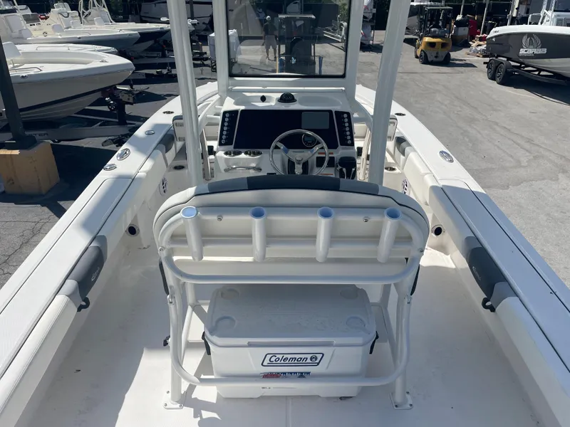 Slide: The Image of 2023 Robalo 246 Cayman boat interior with steering console and Coleman cooler. - 6