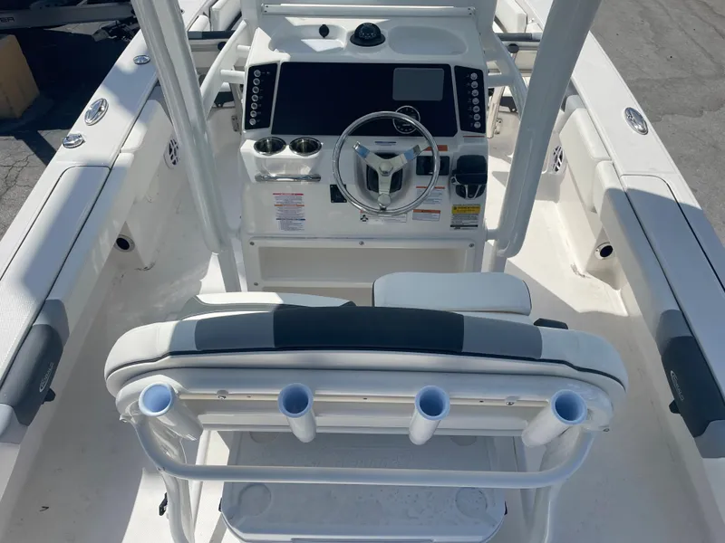 Slide: The Image of 2023 Robalo 246 Cayman boat cockpit with steering wheel and control panel. - 7