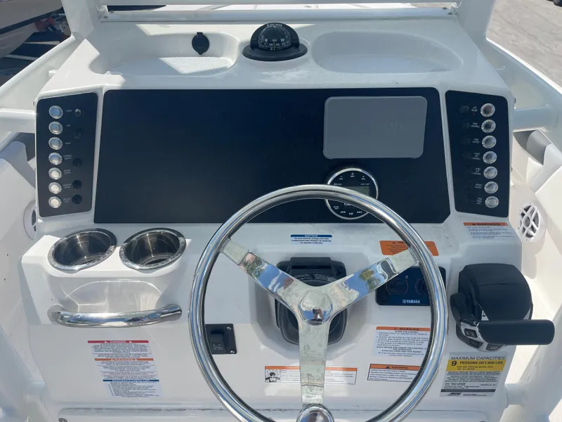 Slide: The Image of Dashboard of 2023 Robalo 246 Cayman boat with steering wheel and control panel. - 8