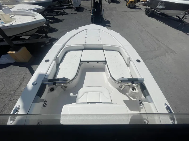 Slide: The Image of 2023 Robalo 246 Cayman boat, spacious deck, sleek design, parked outdoors. - 9
