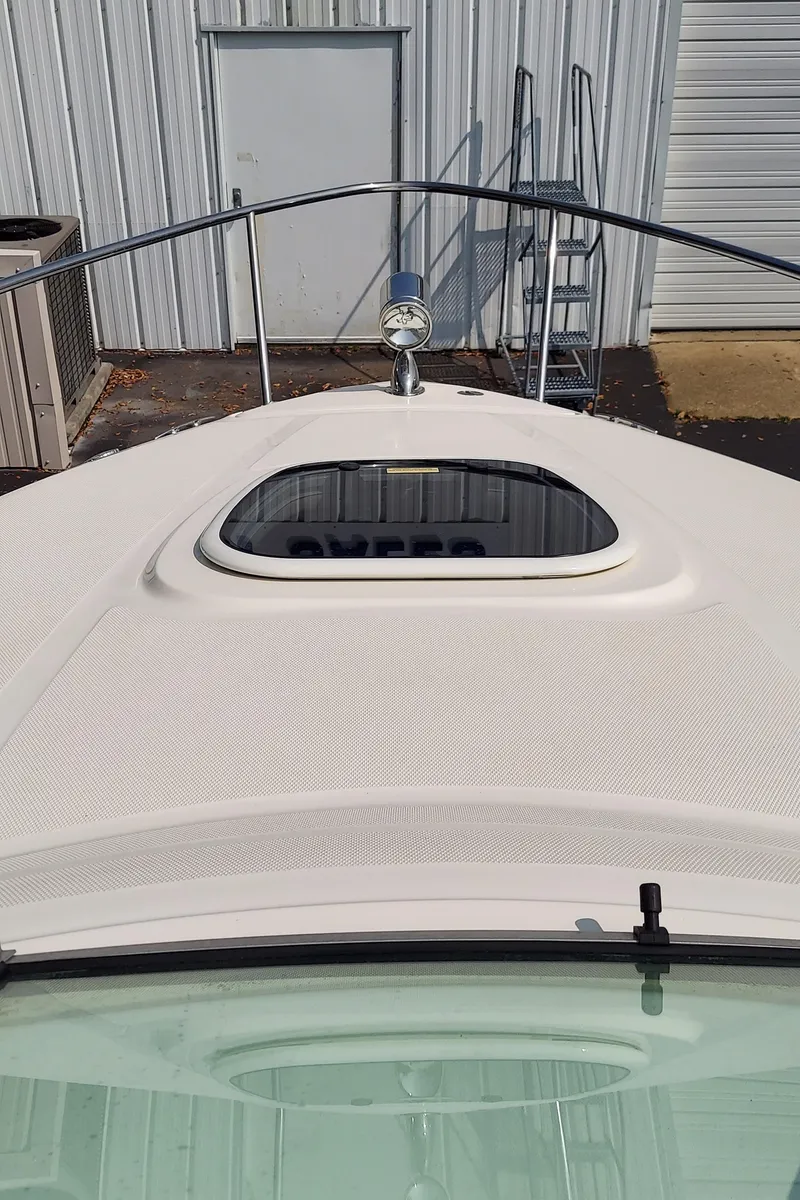 Slide: The Image of 2012 Sea Ray 240 Sundancer boat bow with hatch and railing. - 15