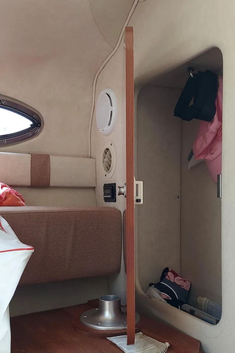 Slide: The Image of Interior cabin of a 2012 Sea Ray 240 Sundancer boat with storage space. - 22