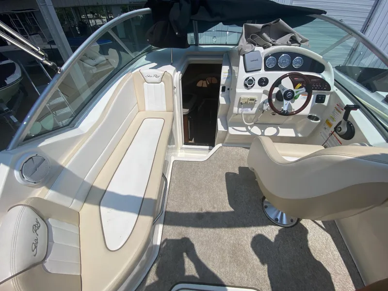 Slide: The Image of Interior of 2012 Sea Ray 240 Sundancer boat with helm and seating area. - 25