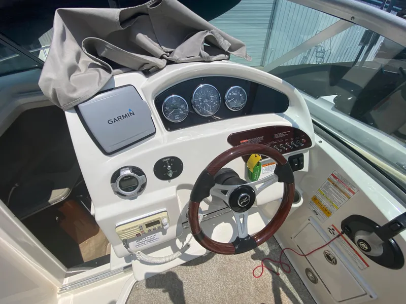 Slide: The Image of 2012 Sea Ray 240 Sundancer helm with Garmin navigation system. - 26