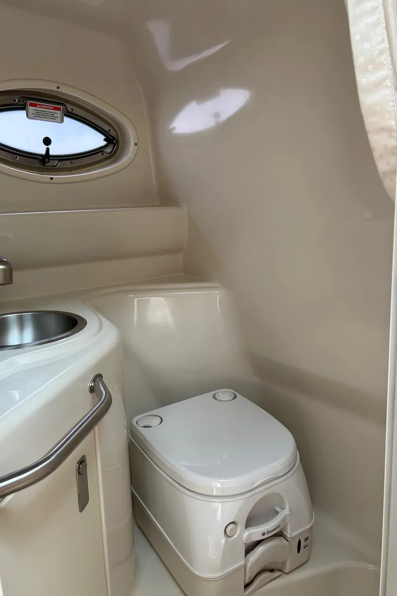 Slide: The Image of 2012 Sea Ray 240 Sundancer boat bathroom with sink and toilet. - 32