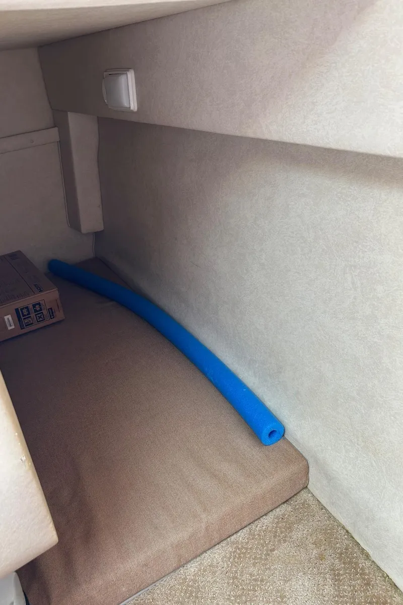 Slide: The Image of Interior cabin of 2012 Sea Ray 240 Sundancer with blue pool noodle. - 33