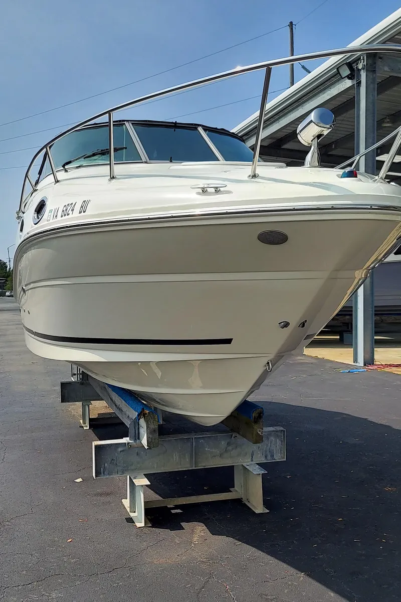Slide: The Image of 2012 Sea Ray 240 Sundancer boat on a trailer in a marina. - 6