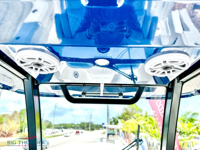 Slide: The Image of 2023 Fountain 38 CC boat interior with blue ceiling and speakers. - 11