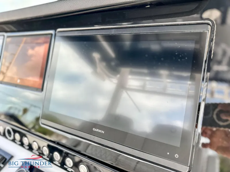 Slide: The Image of Garmin display on 2023 Fountain 38 CC boat dashboard, Big Thunder Marine logo visible. - 15