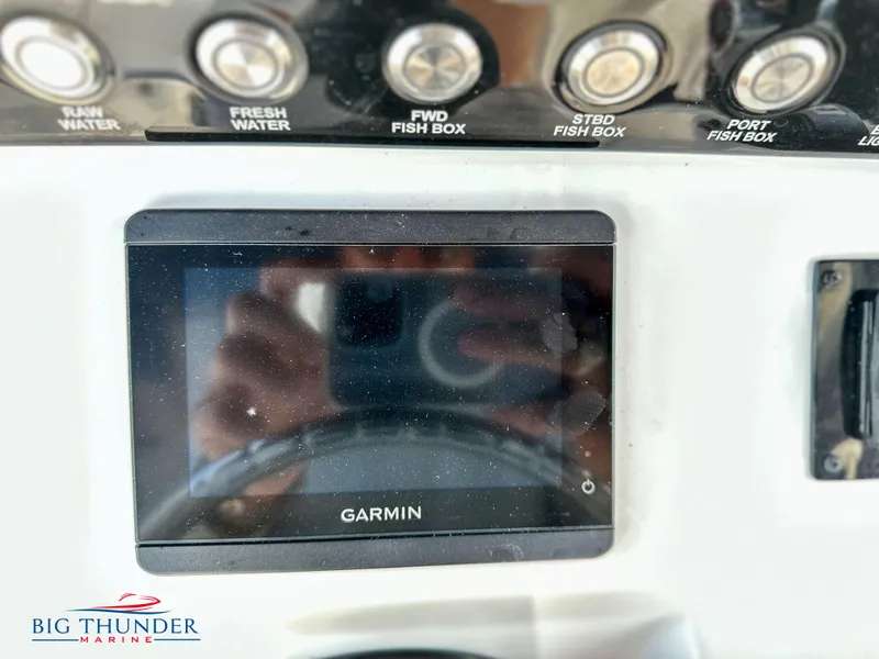 Slide: The Image of Garmin display on 2023 Fountain 38 CC boat dashboard with control buttons. - 18