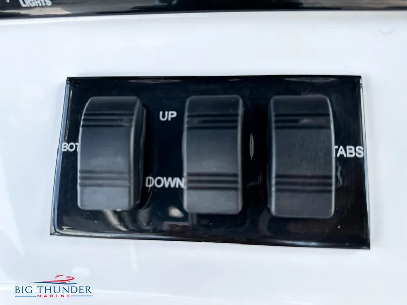 Slide: The Image of Close-up of control switches on a 2023 Fountain 38 CC boat. - 19