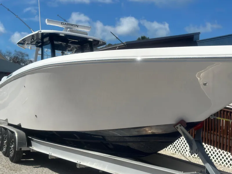 Slide: The Image of 2023 Fountain 38 CC boat on trailer, featuring sleek design and Garmin equipment. - 2