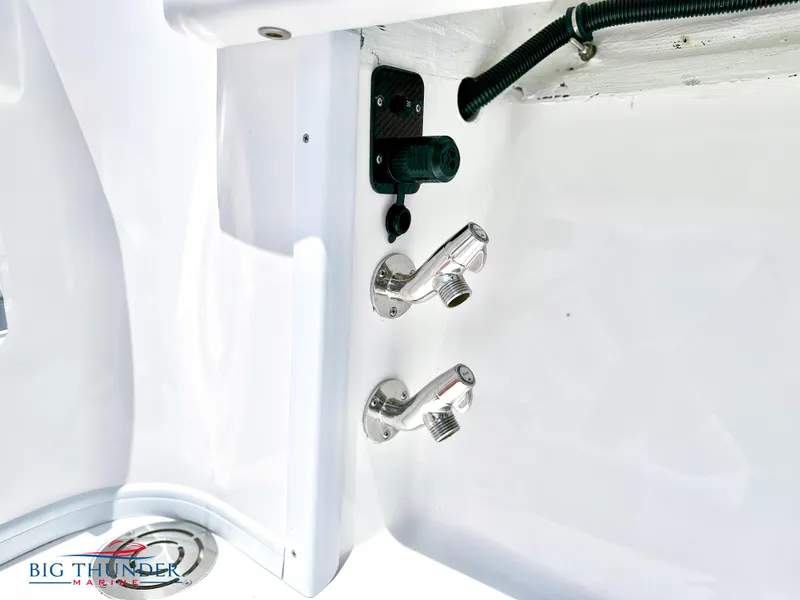 Slide: The Image of Close-up of 2023 Fountain 38 CC boat's water faucets and drain. - 31