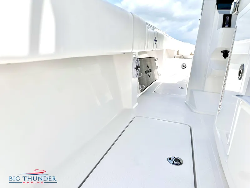 Slide: The Image of 2023 Fountain 38 CC boat interior, white deck, Big Thunder Marine logo. - 35