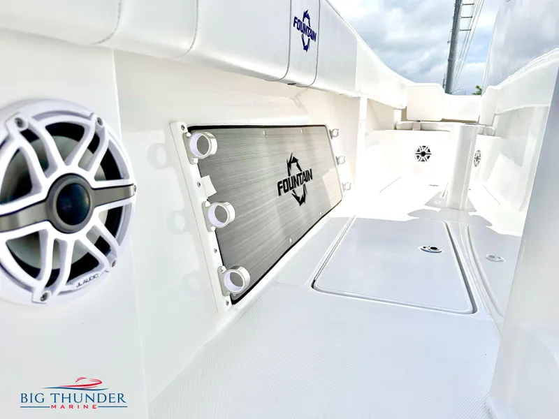 Slide: The Image of 2023 Fountain 38 CC boat interior with speaker and storage compartment. - 36
