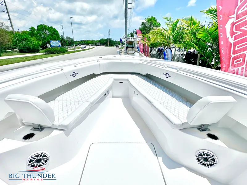 Slide: The Image of 2023 Fountain 38 CC boat with white seating and Big Thunder Marine logo. - 39