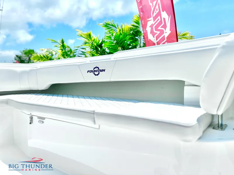 Slide: The Image of 2023 Fountain 38 CC boat interior with white seating and logo. - 41