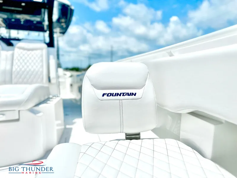 Slide: The Image of 2023 Fountain 38 CC boat interior with white seating, Big Thunder Marine logo. - 42