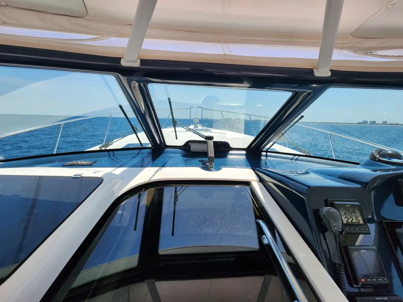 Slide: The Image of Cockpit view of a 2005 Tiara Yachts 3800 Open cruising on the ocean. - 18