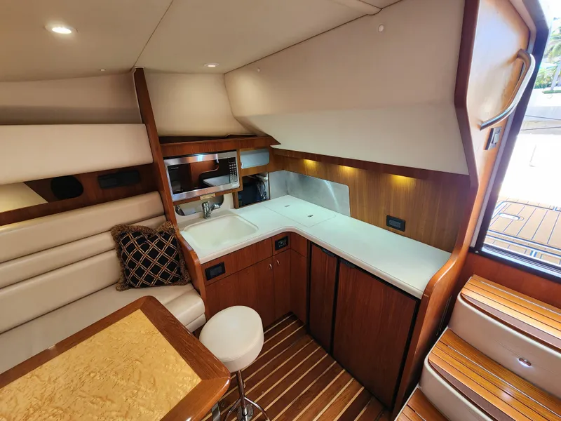 Slide: The Image of 2005 Tiara Yachts 3800 Open interior with kitchen and seating area. - 21