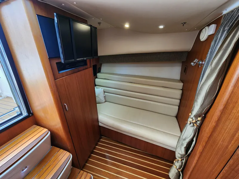 Slide: The Image of 2005 Tiara Yachts 3800 Open interior cabin with seating and TV. - 24