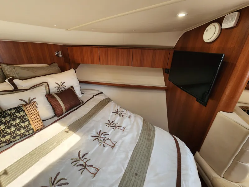 Slide: The Image of 2005 Tiara Yachts 3800 Open cabin with bed, TV, and wooden interior. - 27