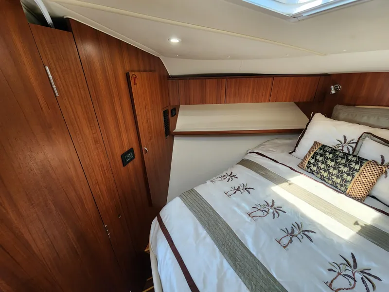 Slide: The Image of 2005 Tiara Yachts 3800 Open cabin with wooden interior and cozy bed. - 28