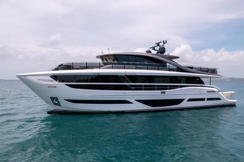 Slide: The Image of Luxury 2021 Princess X95 yacht on calm ocean waters under a cloudy sky. - 17
