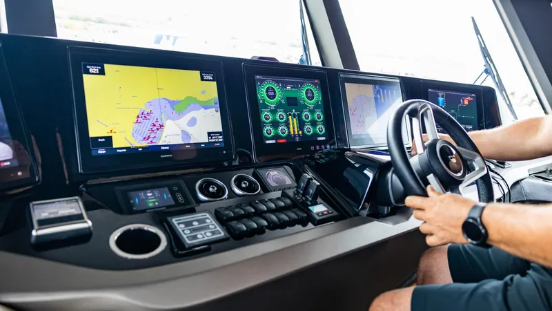 Slide: The Image of Control panel of a 2021 Princess X95 yacht with navigation screens and steering wheel. - 23