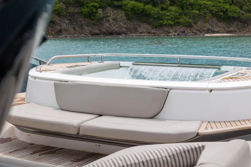 Slide: The Image of Luxurious 2021 Princess X95 yacht with elegant deck and jacuzzi, set against serene waters. - 49