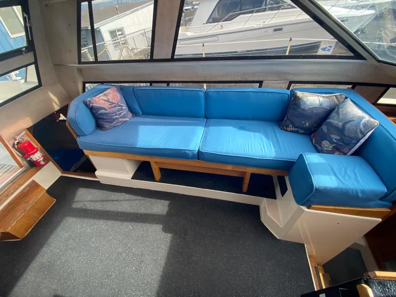 Slide: The Image of Interior of 1985 Nord West 900 boat with blue cushioned seating. - 12