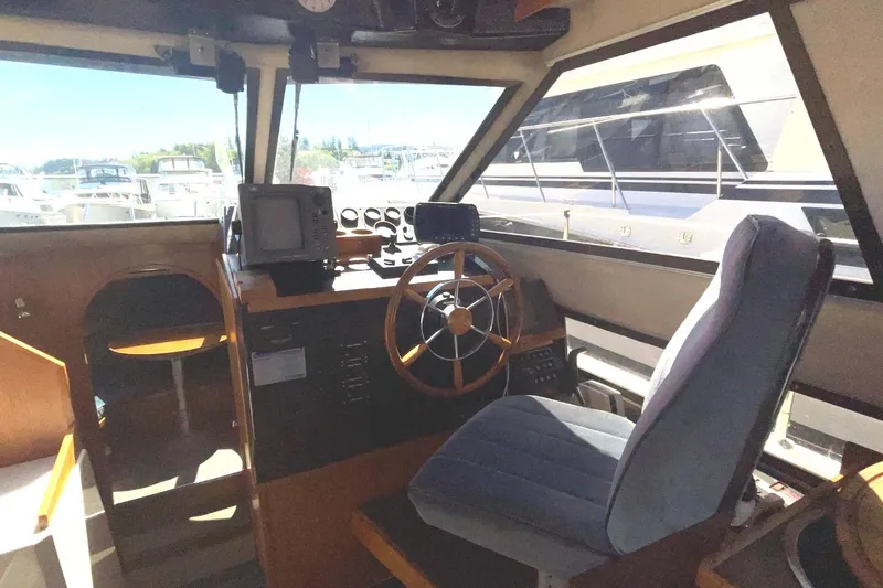 Slide: The Image of Interior of a 1985 Nord West 900 boat, featuring the helm and navigation equipment. - 13