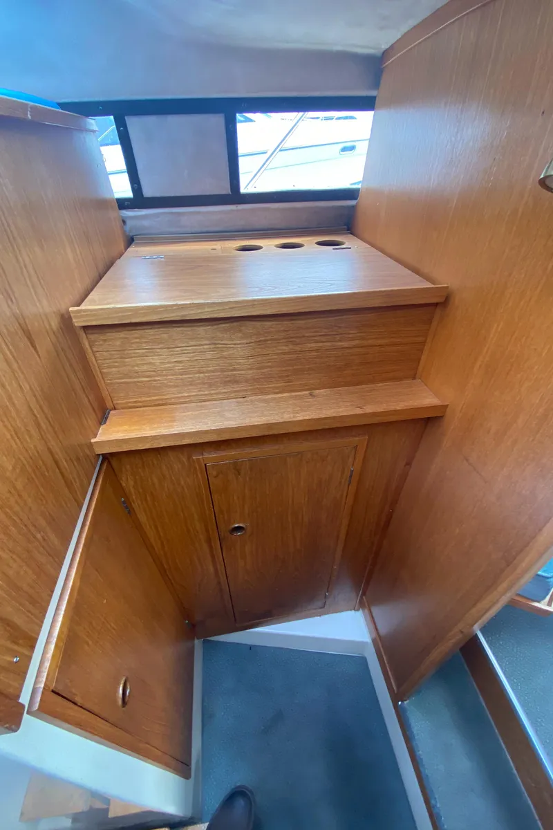 Slide: The Image of Interior of 1985 Nord West 900 boat with wooden cabinetry and storage compartments. - 21