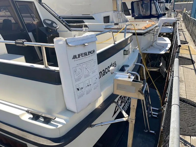 Slide: The Image of Nord West 900 boat docked, featuring Lifesling safety equipment, 1985 model. - 3