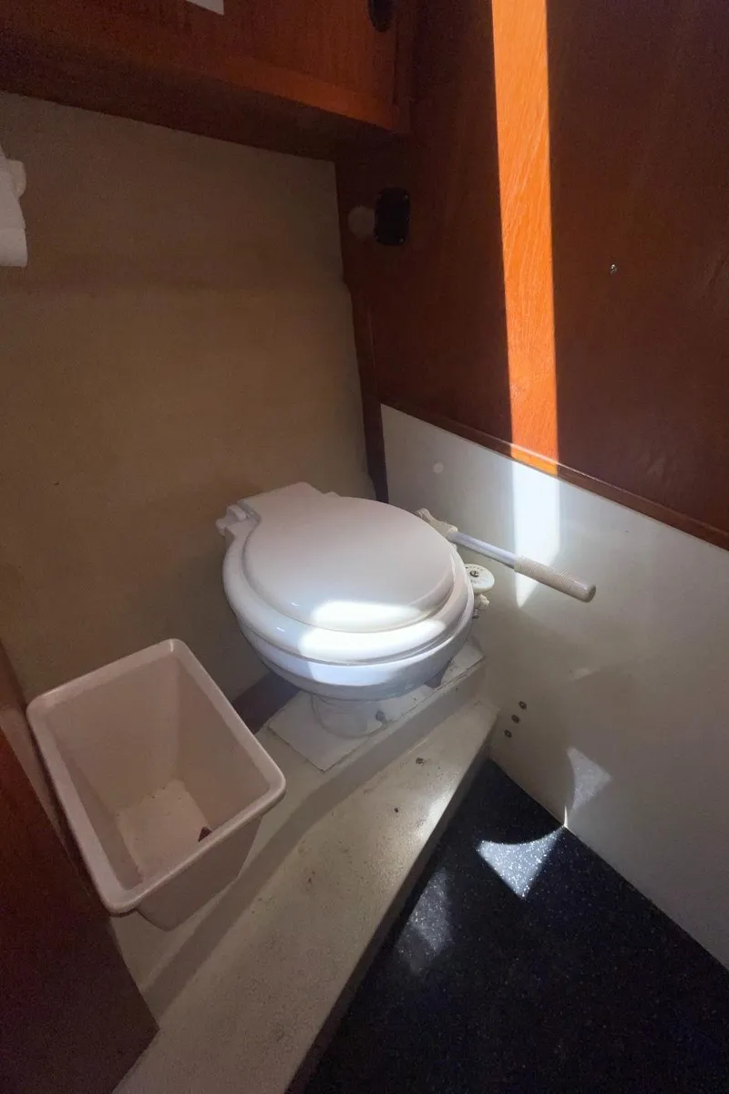 Slide: The Image of Compact bathroom in a 1985 Nord West 900 boat with toilet and waste bin. - 32