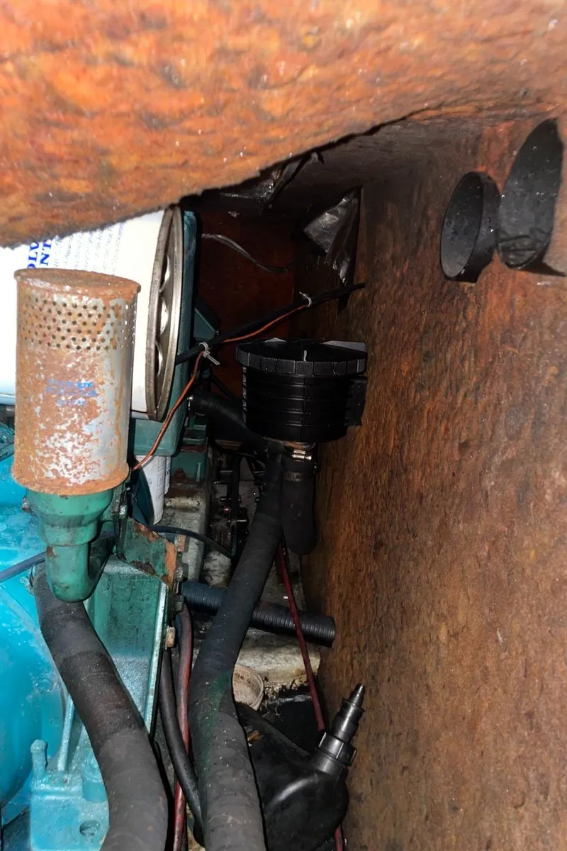 Slide: The Image of Engine compartment of a 1985 Nord West 900 boat showing various mechanical components. - 34