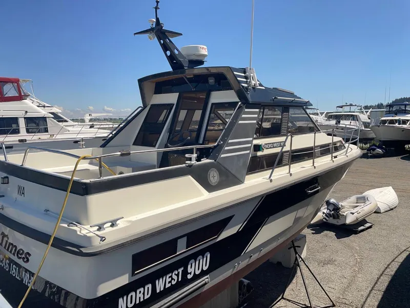 Slide: The Image of 1985 Nord West 900 boat docked at a marina on a sunny day. - 5