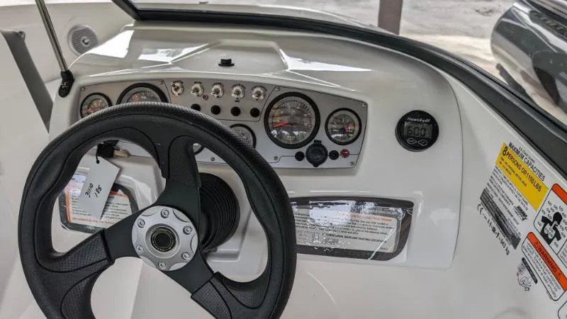 Slide: The Image of 2023 Tahoe 185 S boat dashboard with steering wheel and instrument panel. - 3