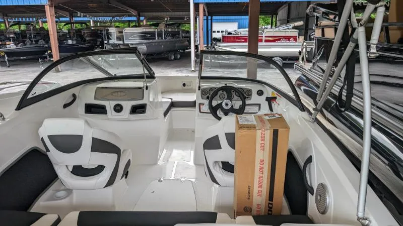 Slide: The Image of 2023 Tahoe 185 S boat interior with steering wheel and seating. - 4