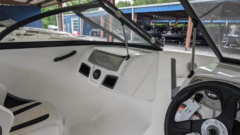 Slide: The Image of 2023 Tahoe 185 S boat interior with steering wheel and dashboard. - 6