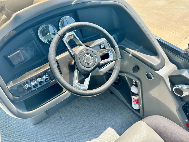 Slide: The Image of 2023 Tahoe Pontoon Cascade Cruise 23 FT Triple 25 steering console with gauges and controls. - 6