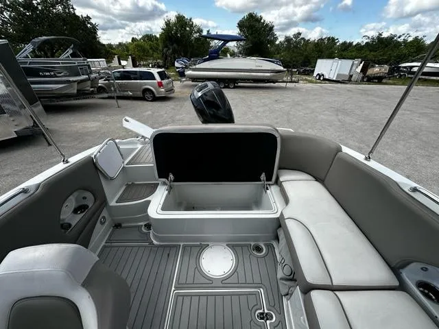 Slide: The Image of 2019 Crownline 205XS boat interior with seating and storage compartments. - 14