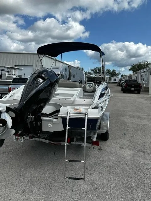 Slide: The Image of 2019 Crownline 205XS boat with outboard motor and ladder. - 3