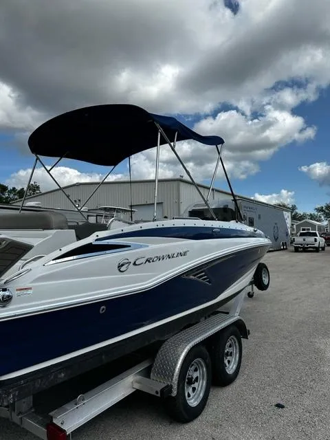 Slide: The Image of 2019 Crownline 205XS boat on a trailer with a blue canopy. - 4