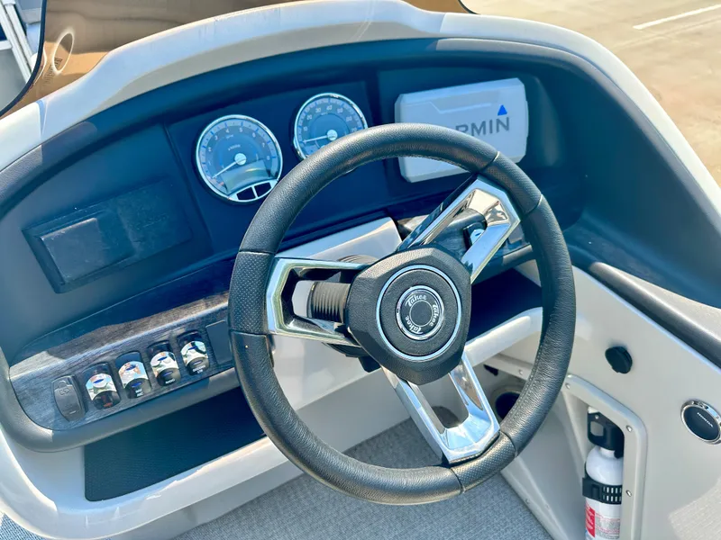 Slide: The Image of 2023 Tahoe Pontoon 23 FT Cascade Rear Fish Triple 25 dashboard with steering wheel and gauges. - 7
