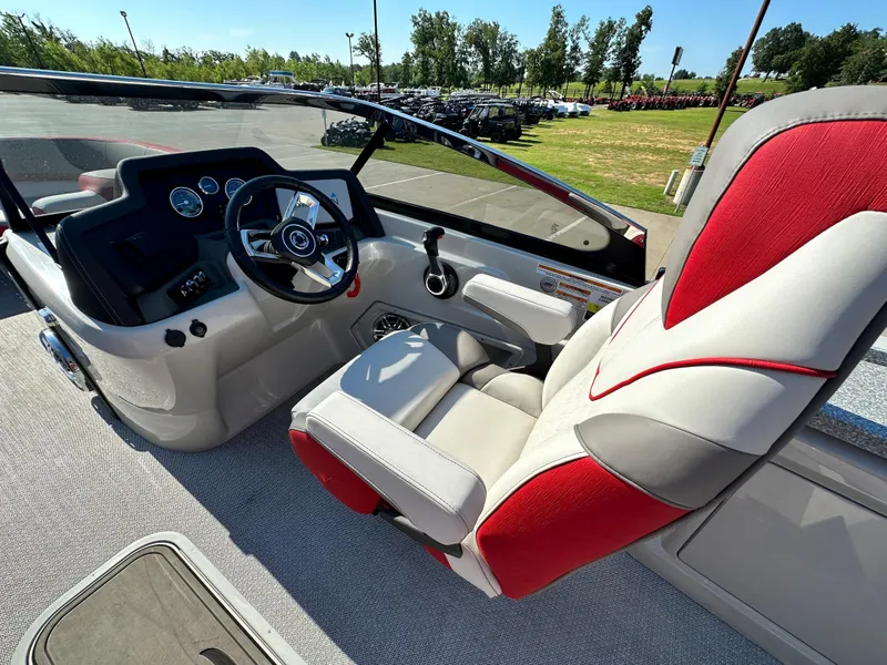 Slide: The Image of 2023 Tahoe Pontoon Cascade Versatile Rear Bench 25 FT Triple 25 SP cockpit with steering wheel and captain's chair. - 13