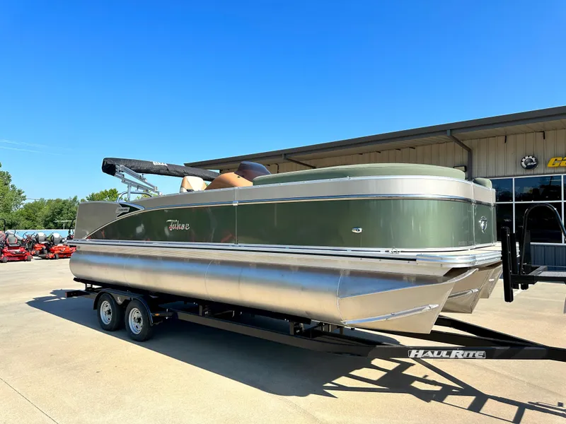 Slide: The Image of 2023 Tahoe Pontoon Cascade Versatile Rear Lounger on trailer, parked outdoors. - 21