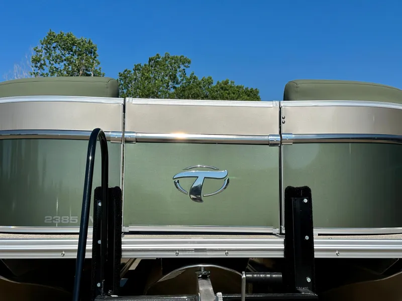 Slide: The Image of 2023 Tahoe Pontoon Cascade Versatile Rear Lounger, rear view with logo and green exterior. - 22